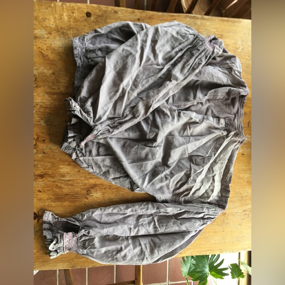 Heavily worn, purple pheasant blouse.